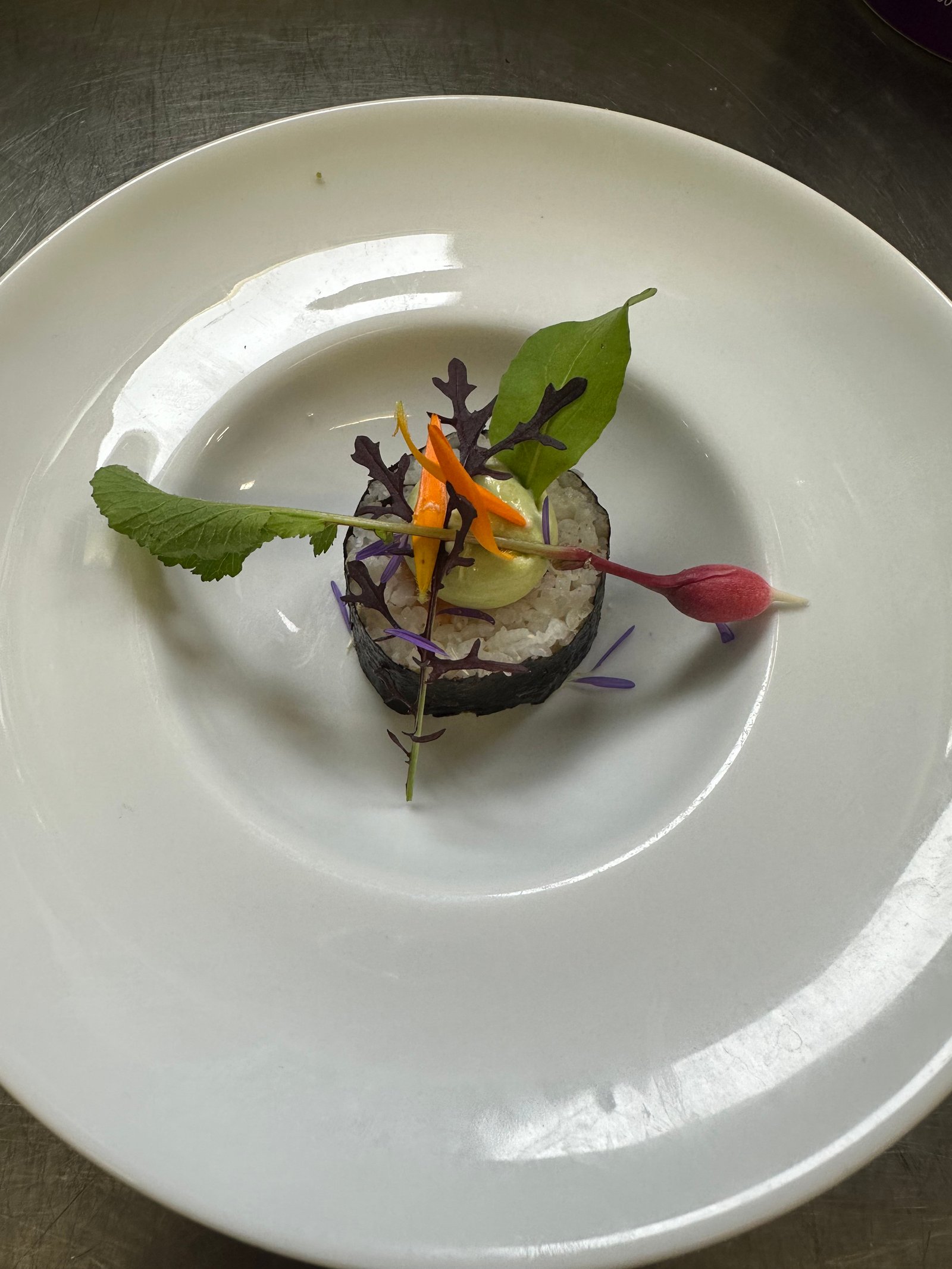 Senior man serving fish for family at Christmas dinner